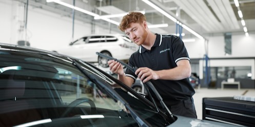 Technician changing wiper blade